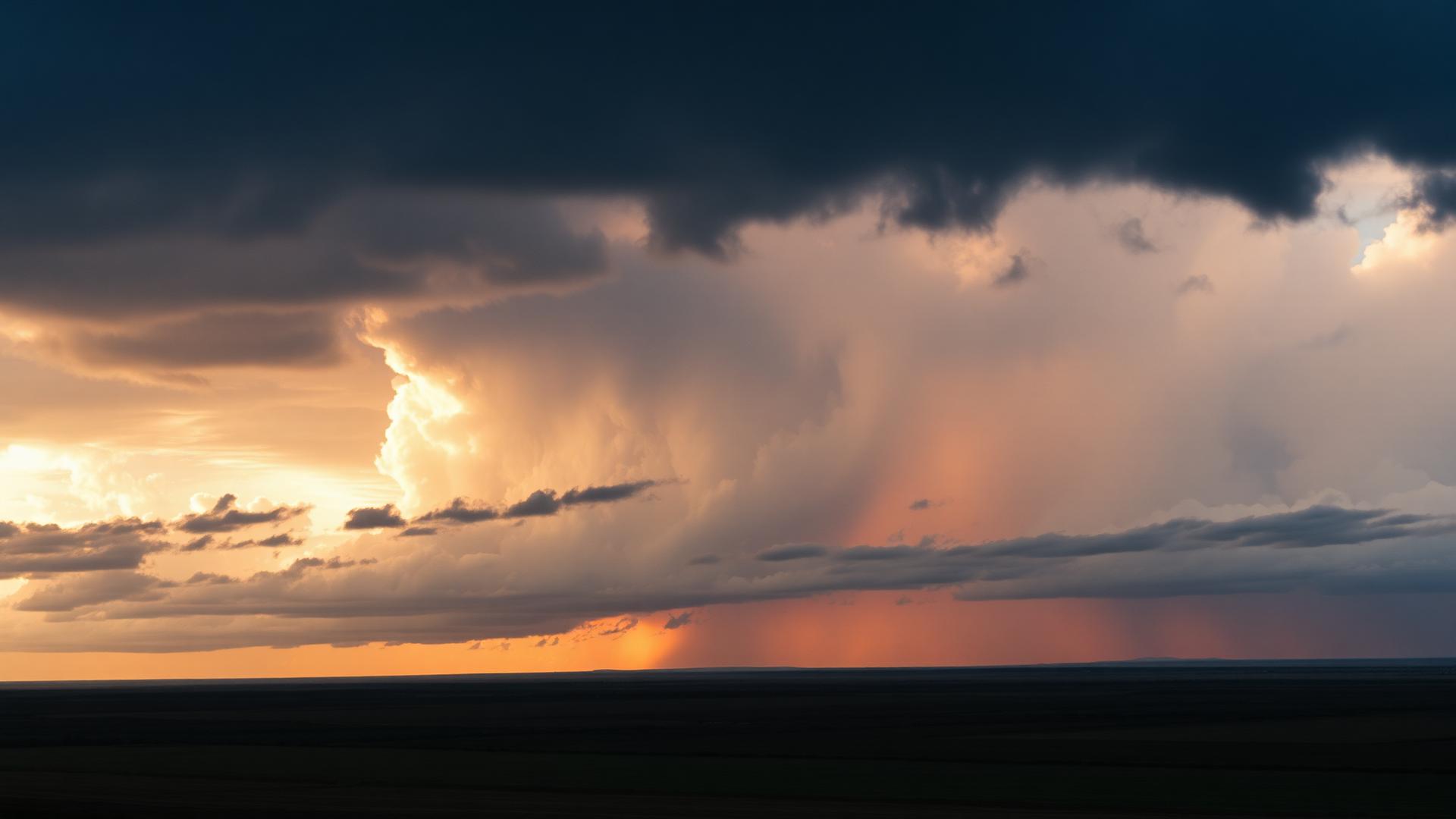 Dramatic storm clouds edged with warm sunset light.